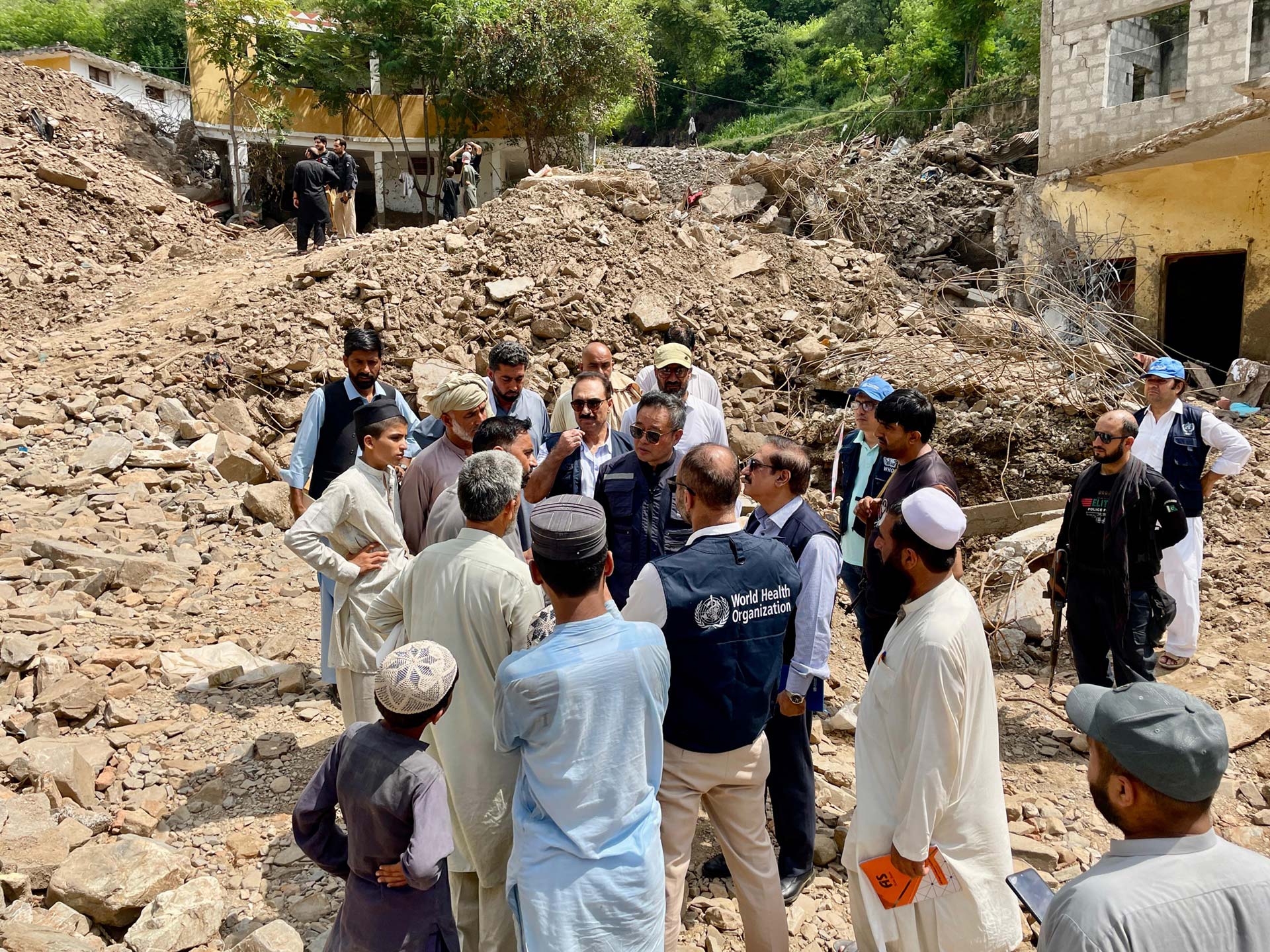 WHO Representative and teams during a visit with provincial authorities to evaluate the impact of a recent cloudburst in Dalori Bala village, Swabi District, in Khyber Pakhtunkhwa (KP). Photo: WHO/Hamid Ina WHO Representative and teams during a visit with provincial authorities to evaluate the impact of a recent cloudburst in Dalori Bala village, Swabi District, in Khyber Pakhtunkhwa (KP). Photo: WHO/Hamid Ina