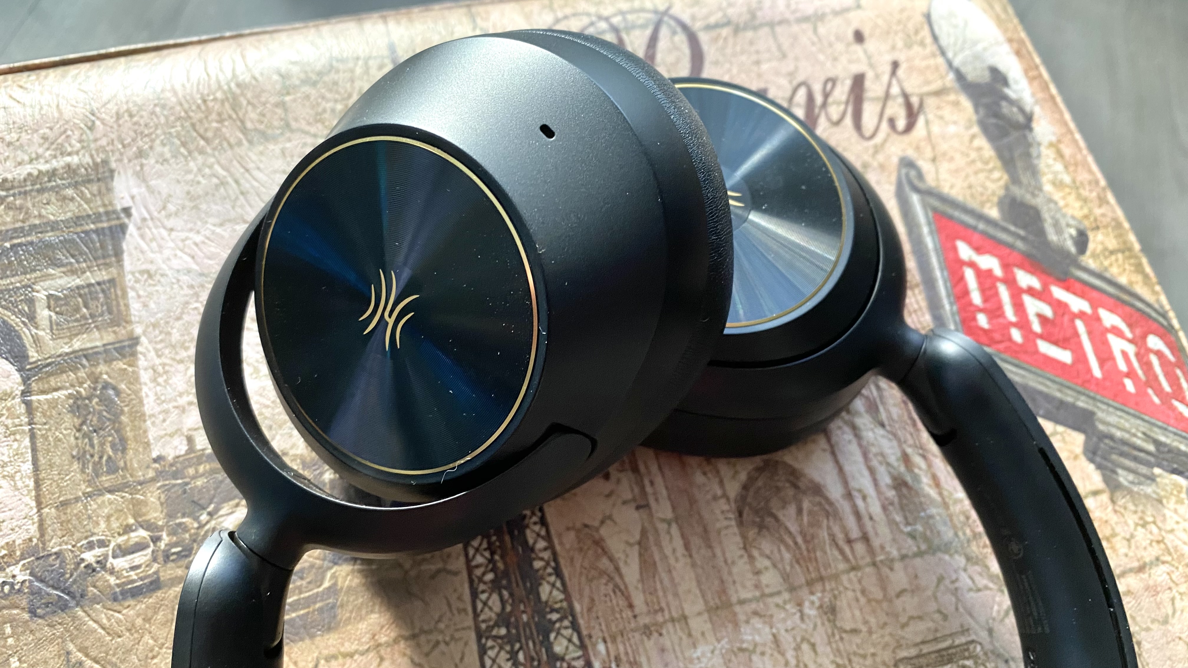 Earcups of the OneOdio Focus A6 over-ear heaphones on a Parisian stool