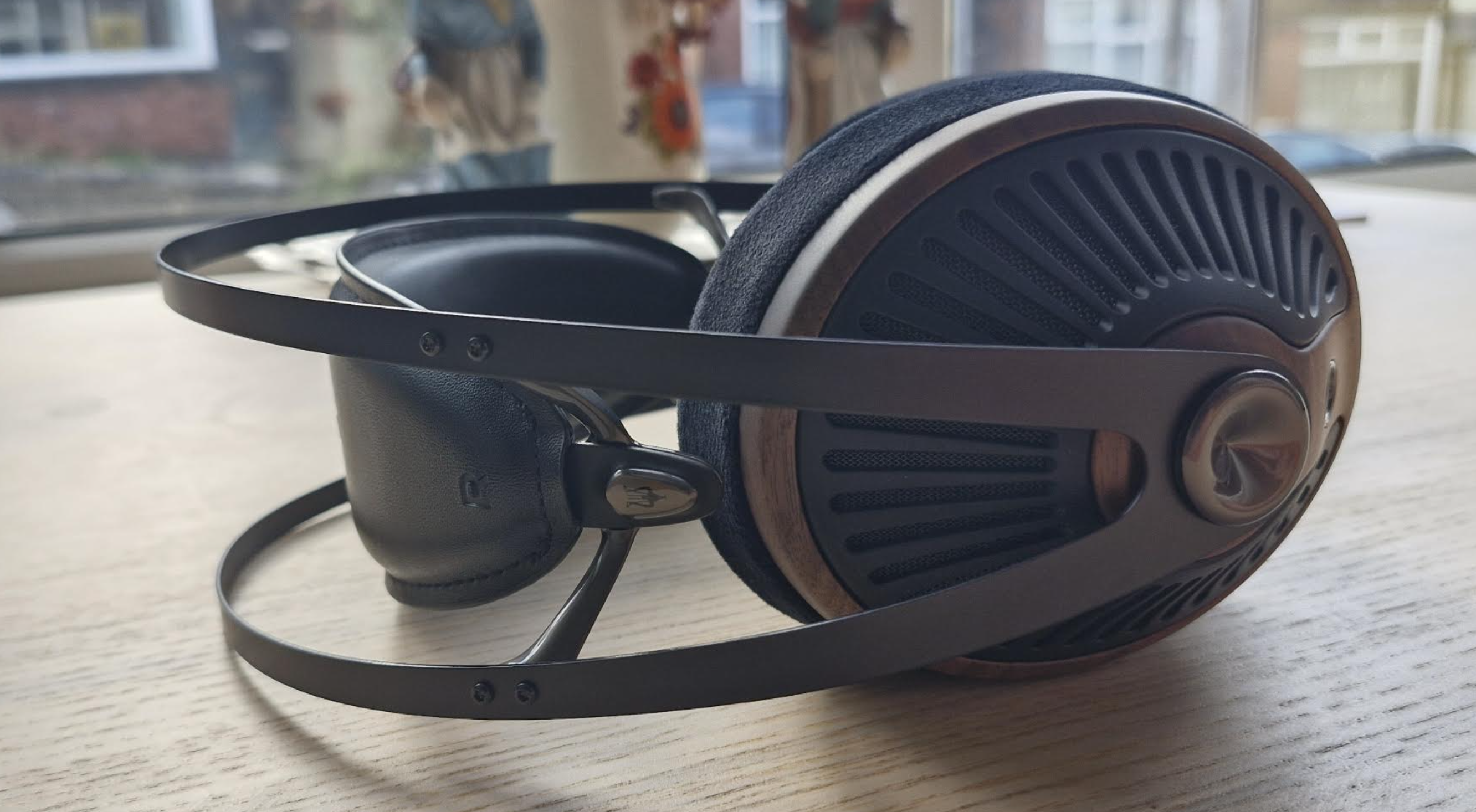 Meze Audio 105 Silva headphones on a light wooden table 