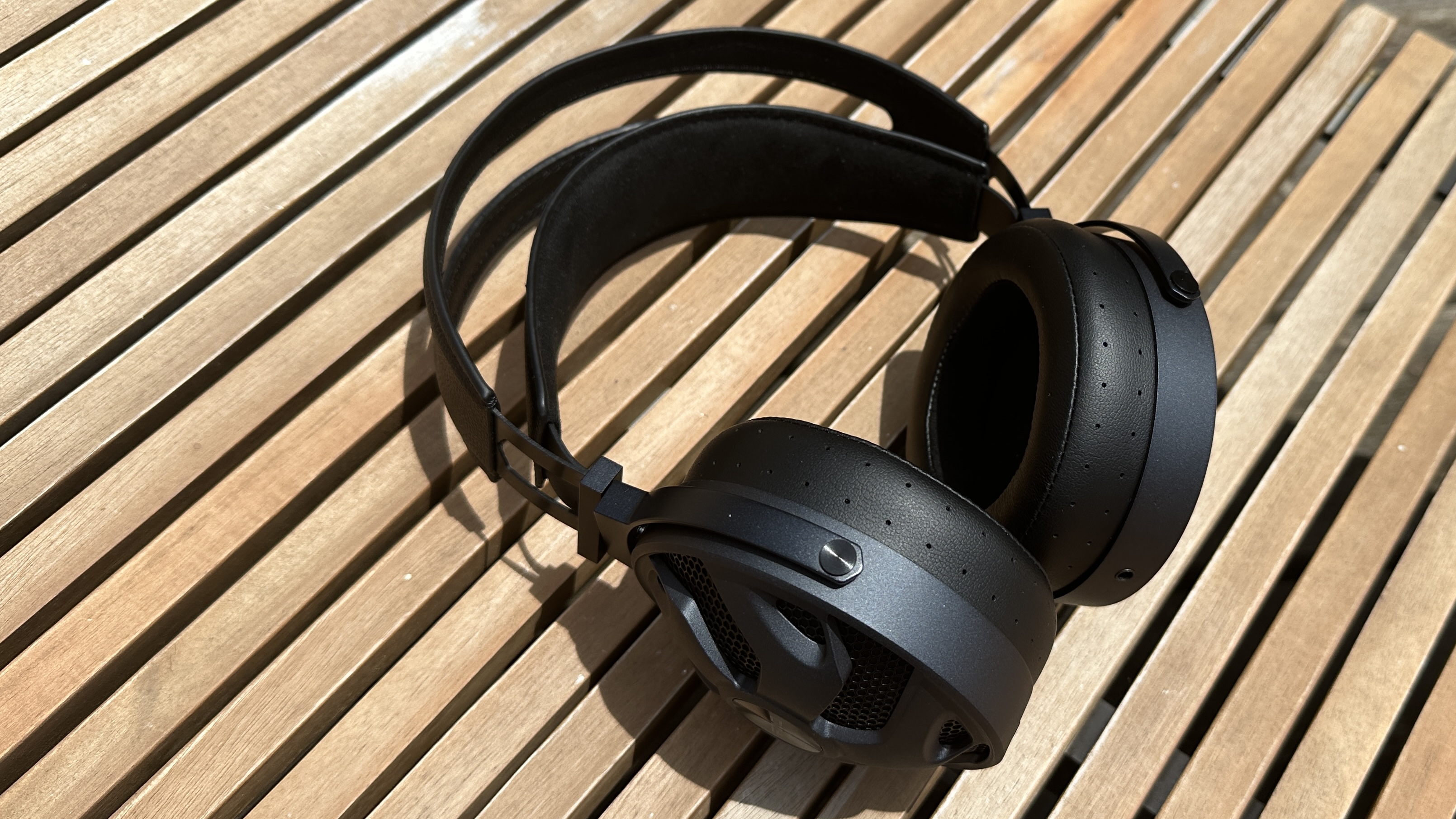 The FiiO FT3 headphones on a wooden surface.