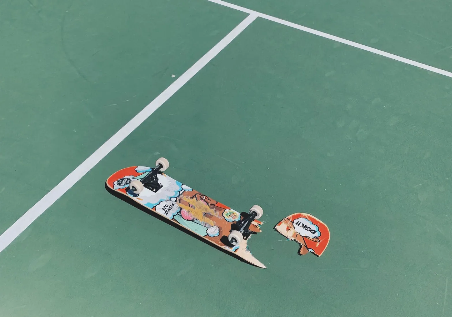 Broken skateboard on green tennis court edited with A6 Pro VSCO Preset filter