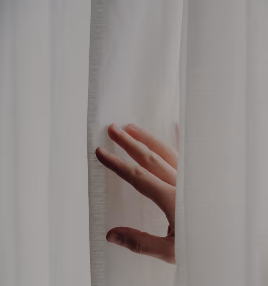 Photo of hand between white curtains from a photography blog