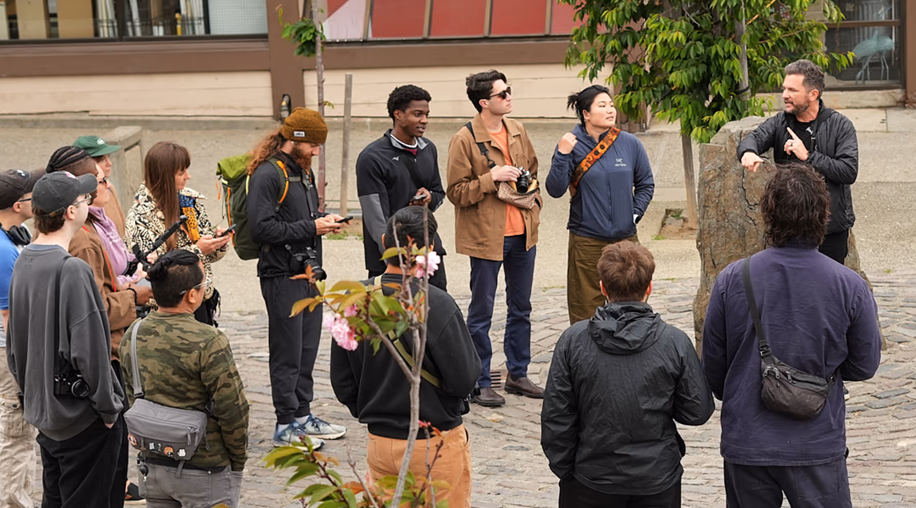 Group of photographers gathered on a photo walk listening to Zach Hodges speaking